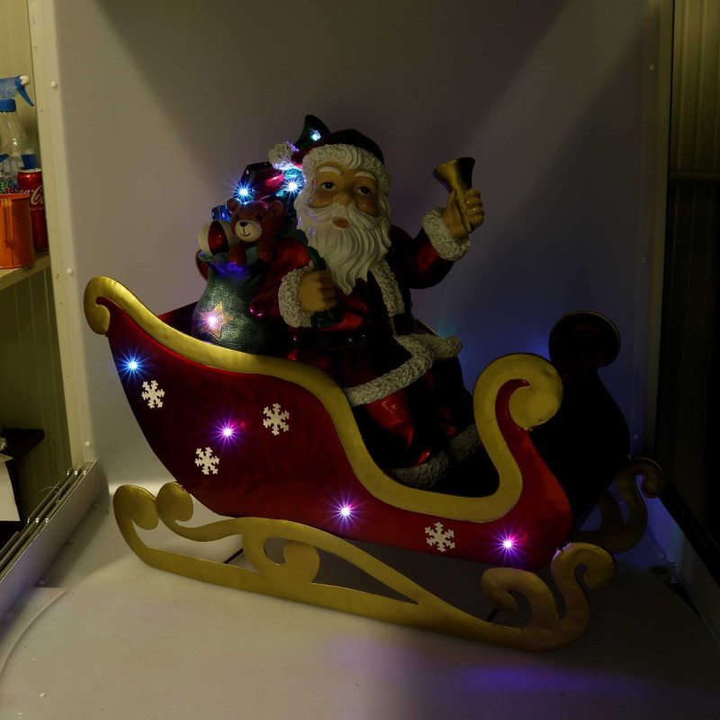 Babbo Natale resina su slitta metallo rosso LED 64x26x60 cm